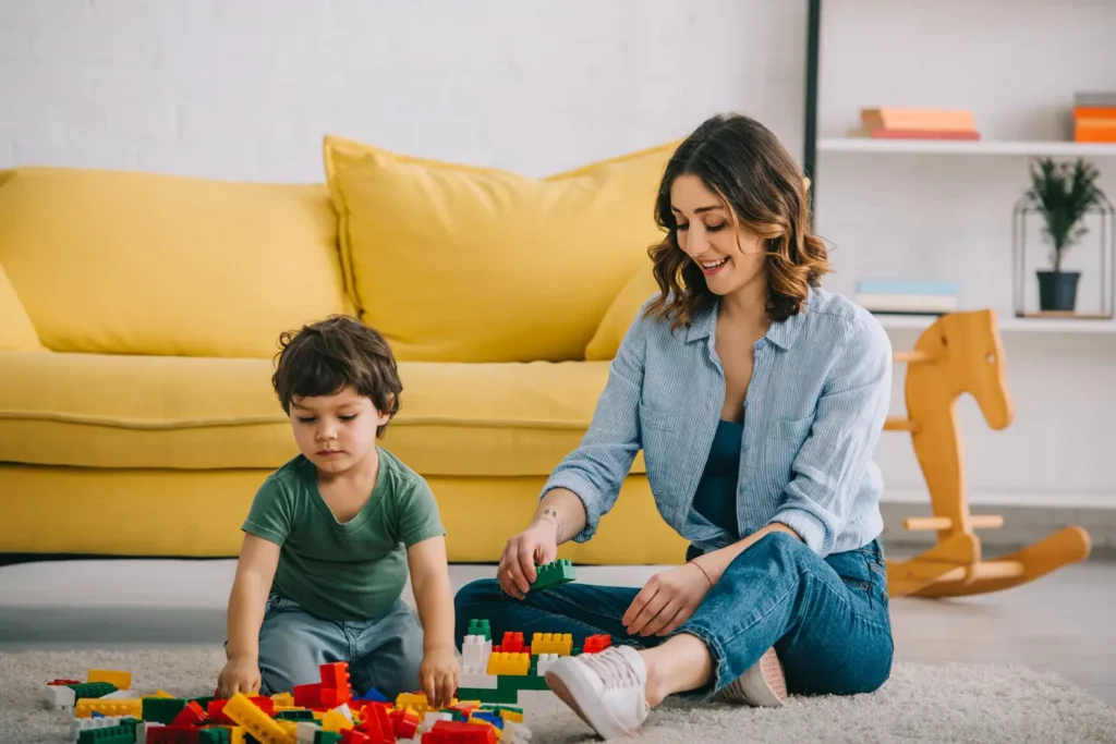 mom and son playing with toy blocks in living room 2023 05 03 02 30 05 utc